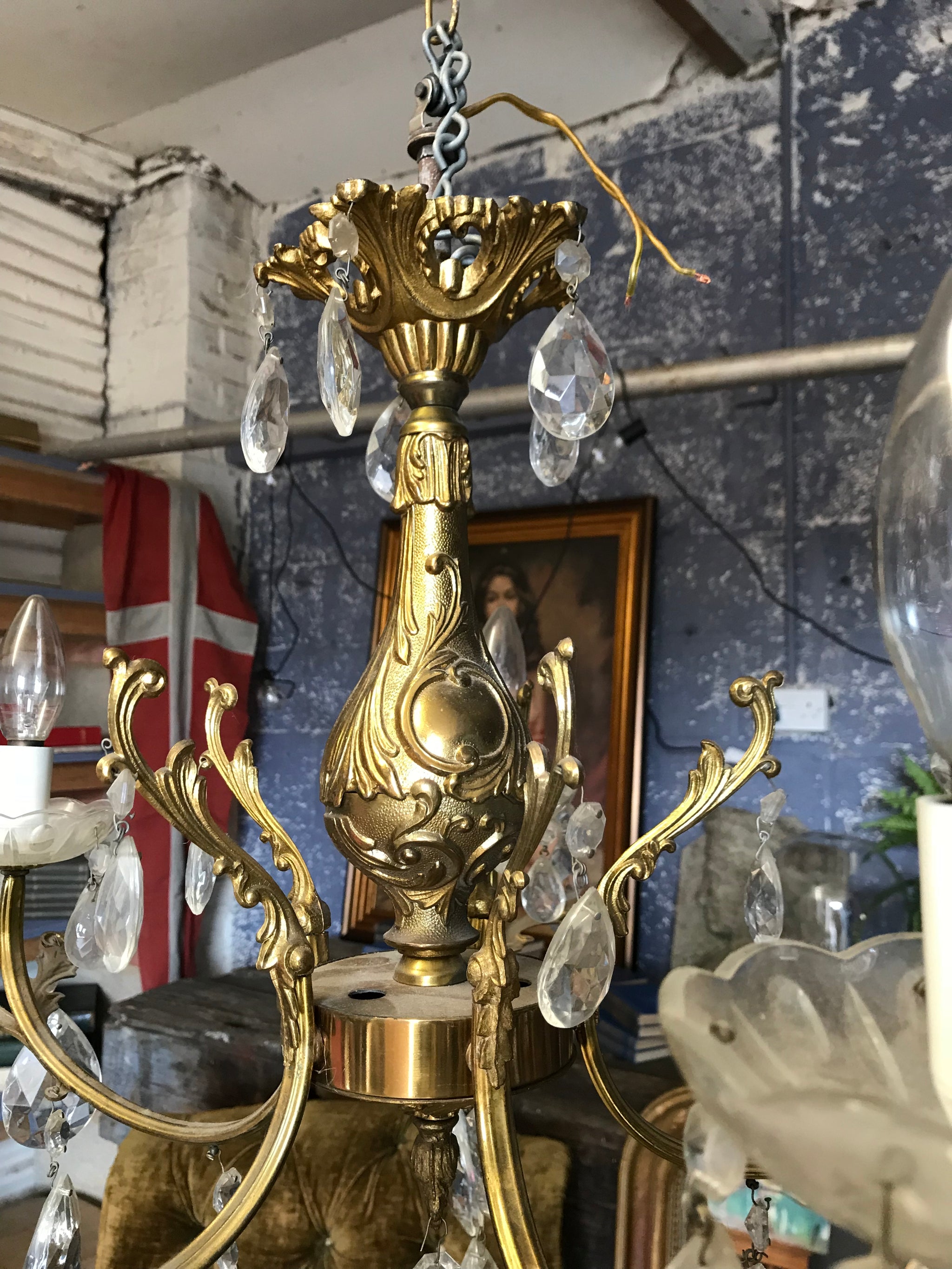 A medium 5 arm crystal drop and gilt body chandelier