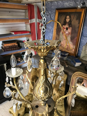 A medium 5 arm crystal drop and gilt body chandelier