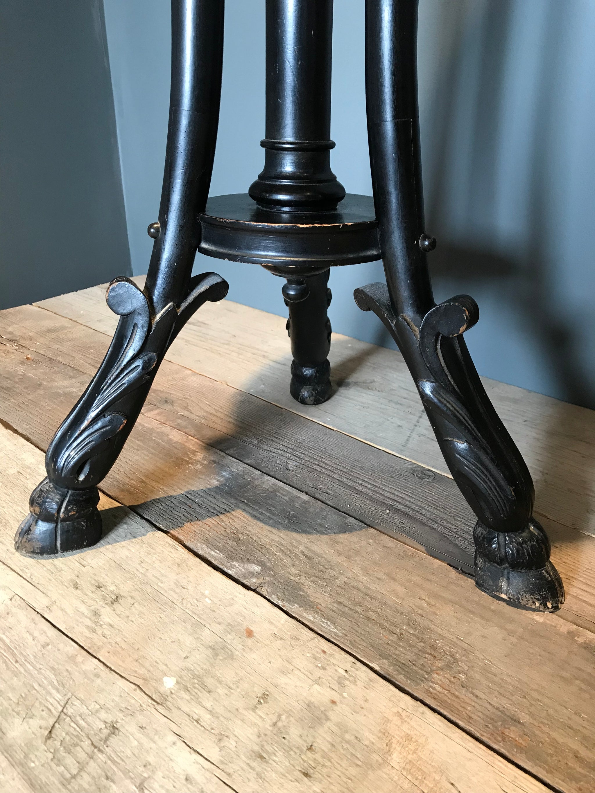 A Gothic goat hoof ebonised jardiniere plant display stand