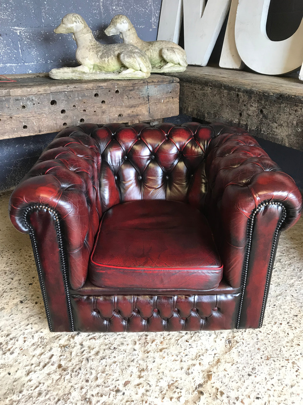 An oxblood red Chesterfield armchair with button back