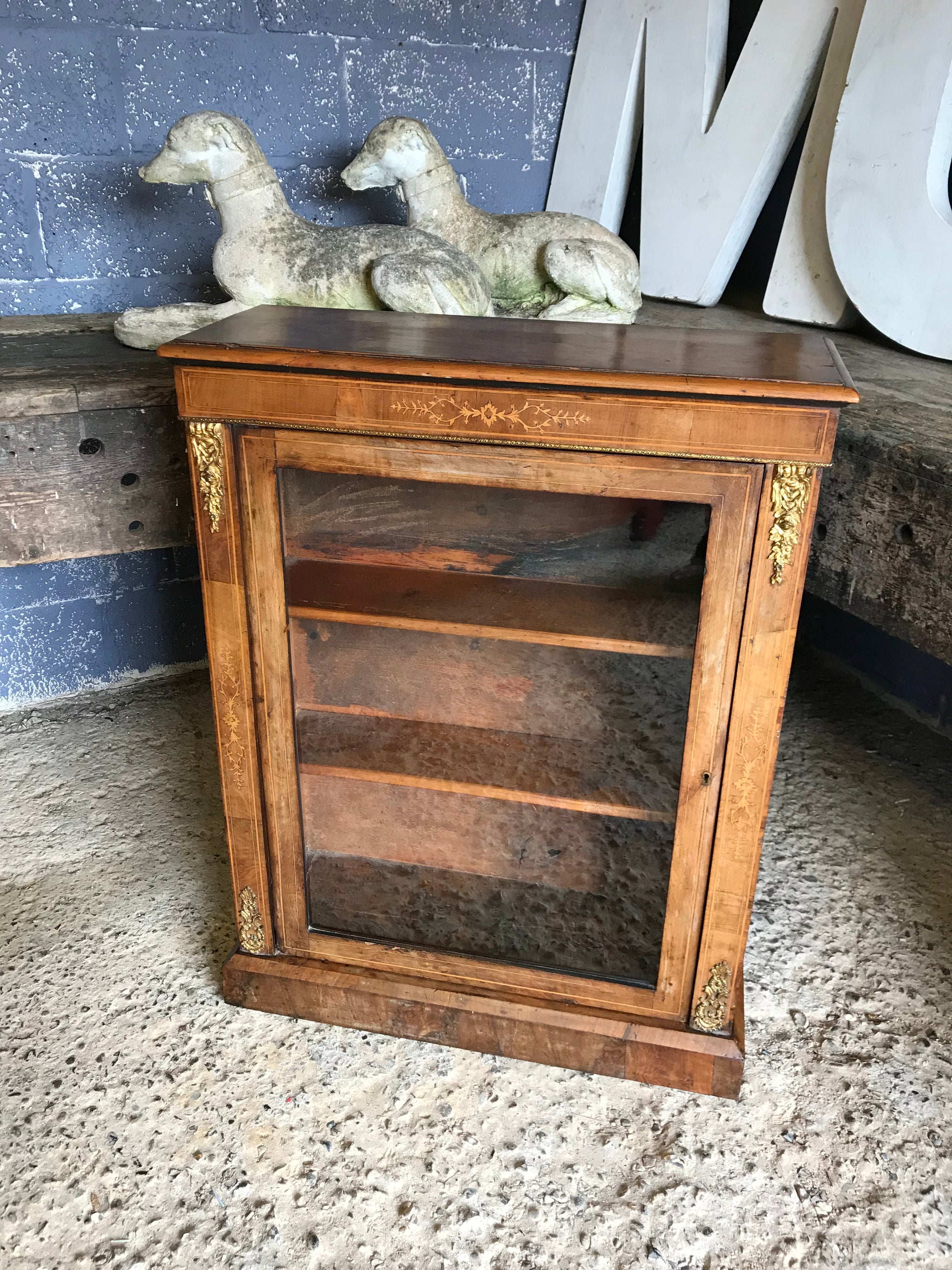 A Victorian single door inlaid walnut pier display cabinet