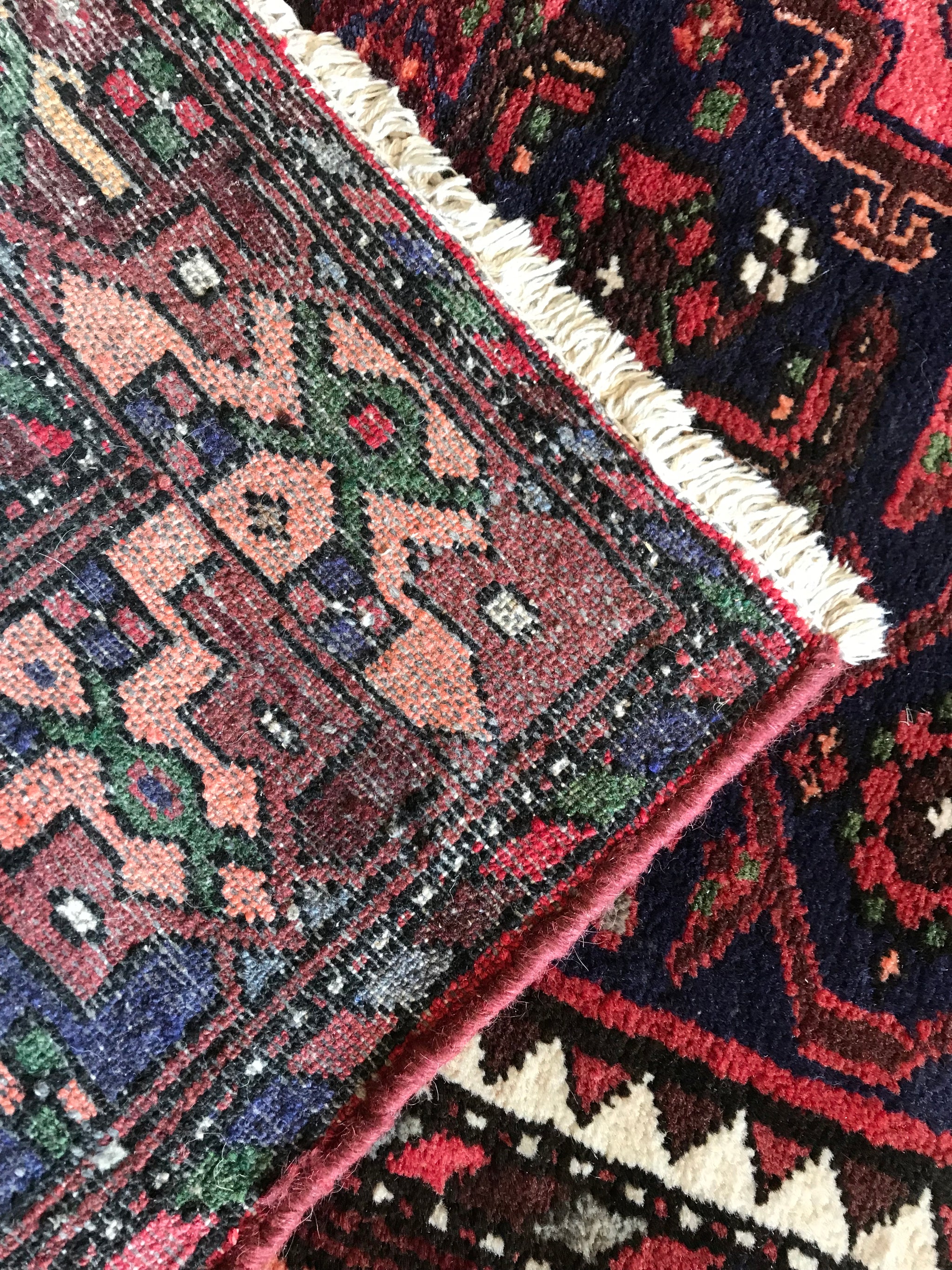A red ground wool Persian rug