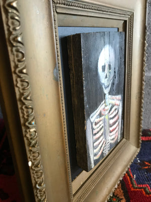 A small Memento Mori naive skeleton vanitas oil painting