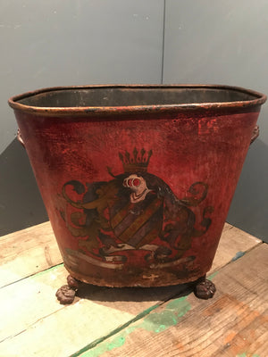 A heraldic chateau fireside log bucket