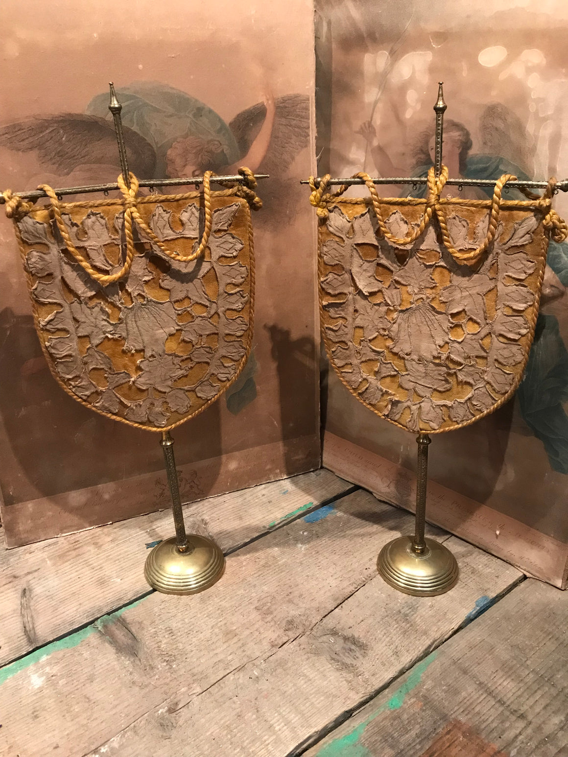 A pair of velvet face screens on brass stands