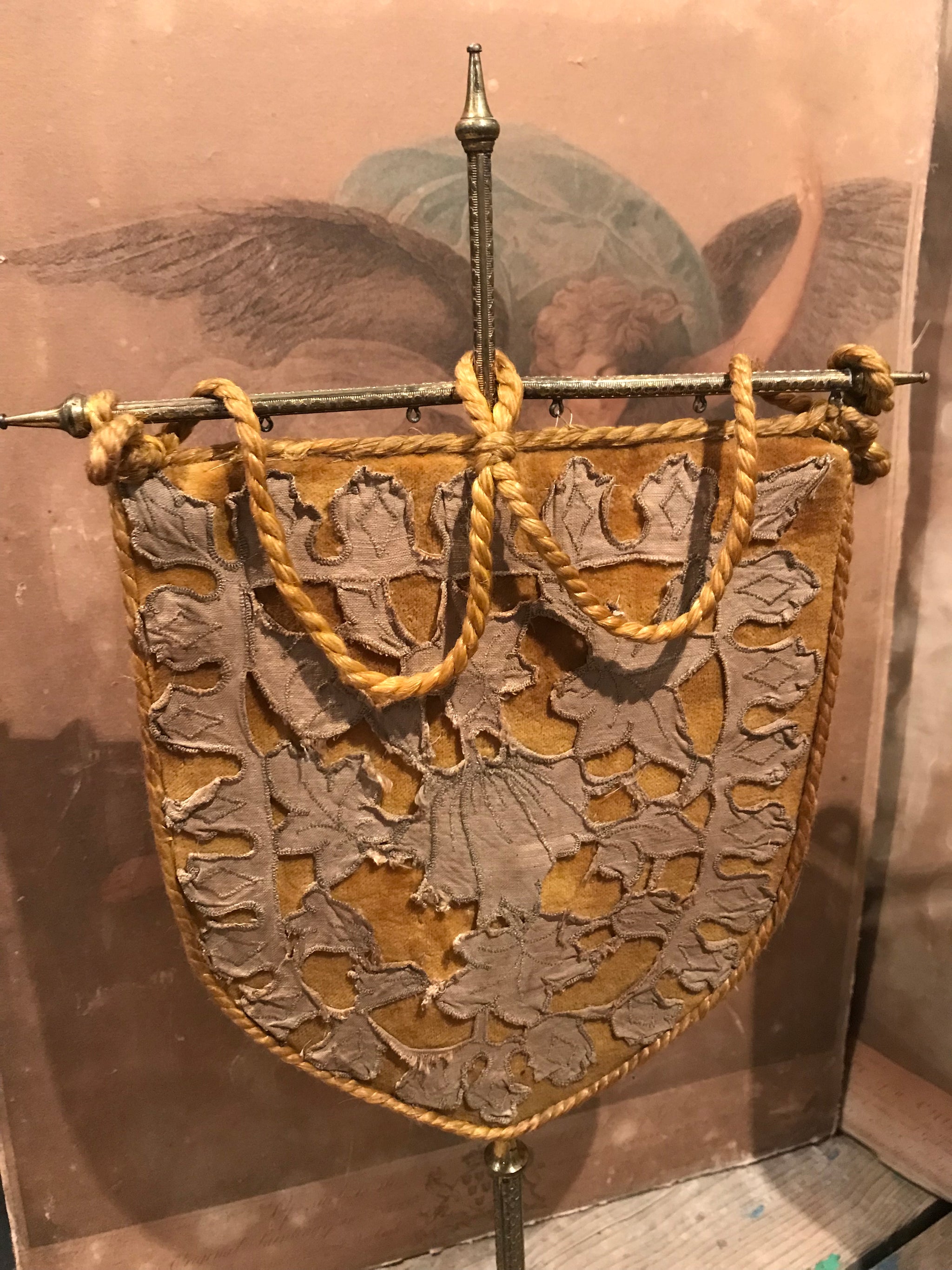 A pair of velvet face screens on brass stands