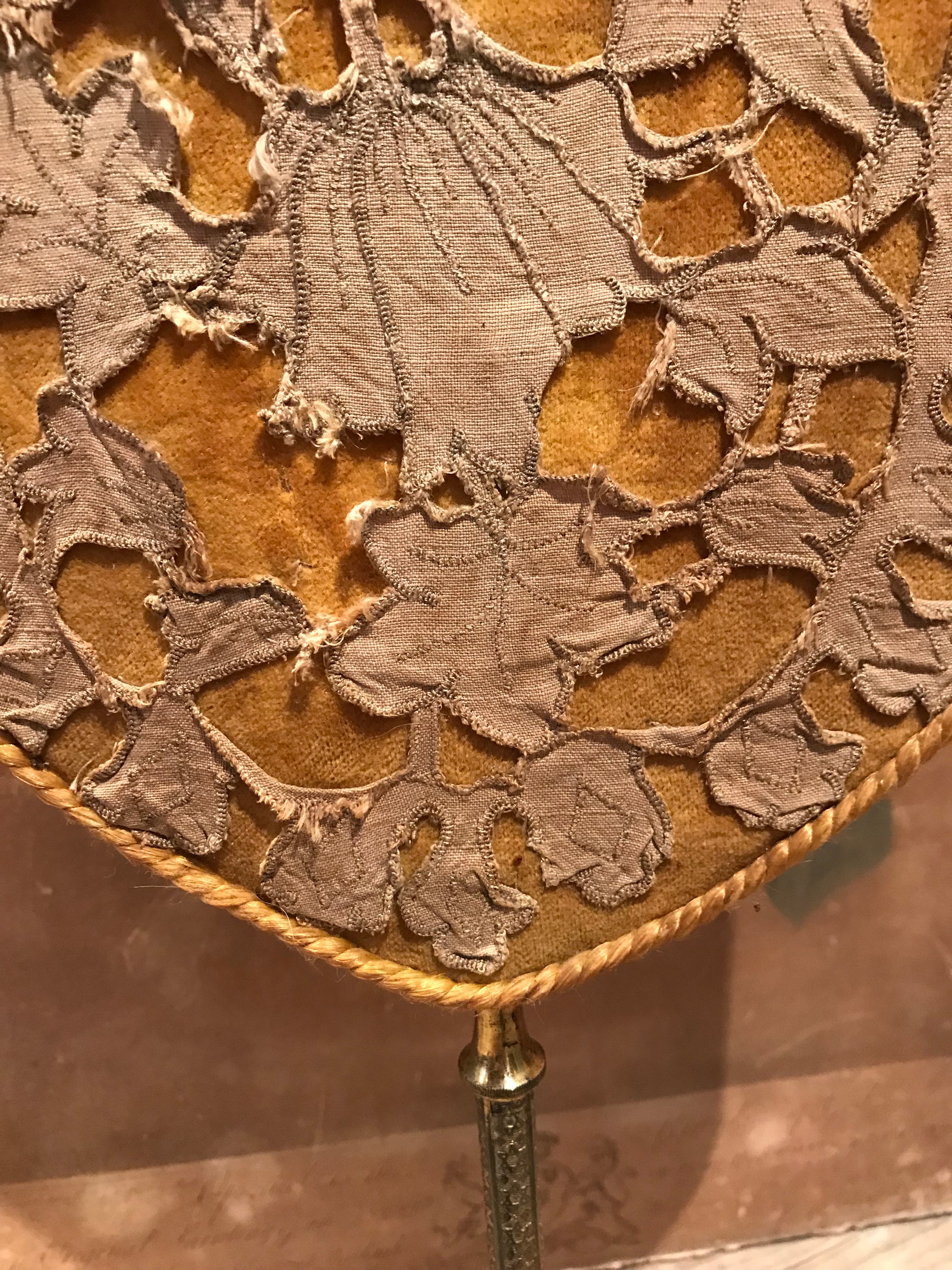 A pair of velvet face screens on brass stands