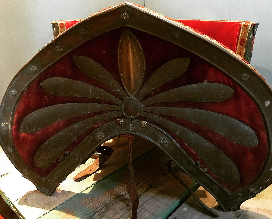 A red velvet and worked metal horse saddle