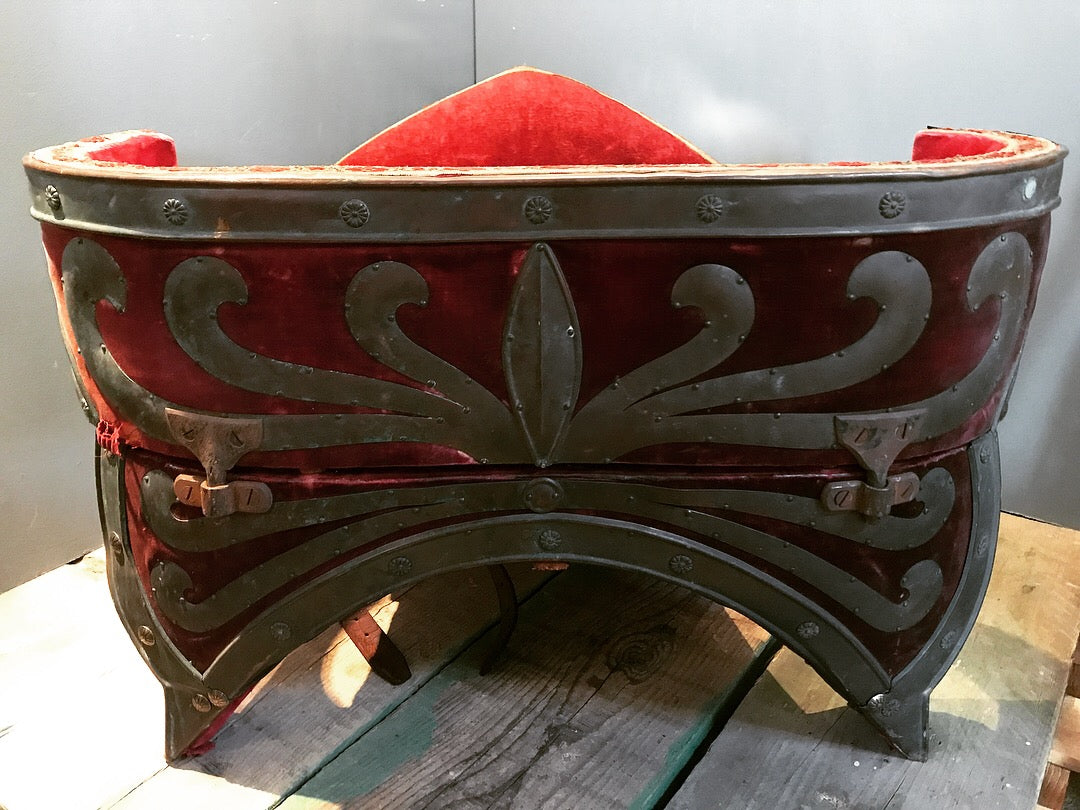 A red velvet and worked metal horse saddle