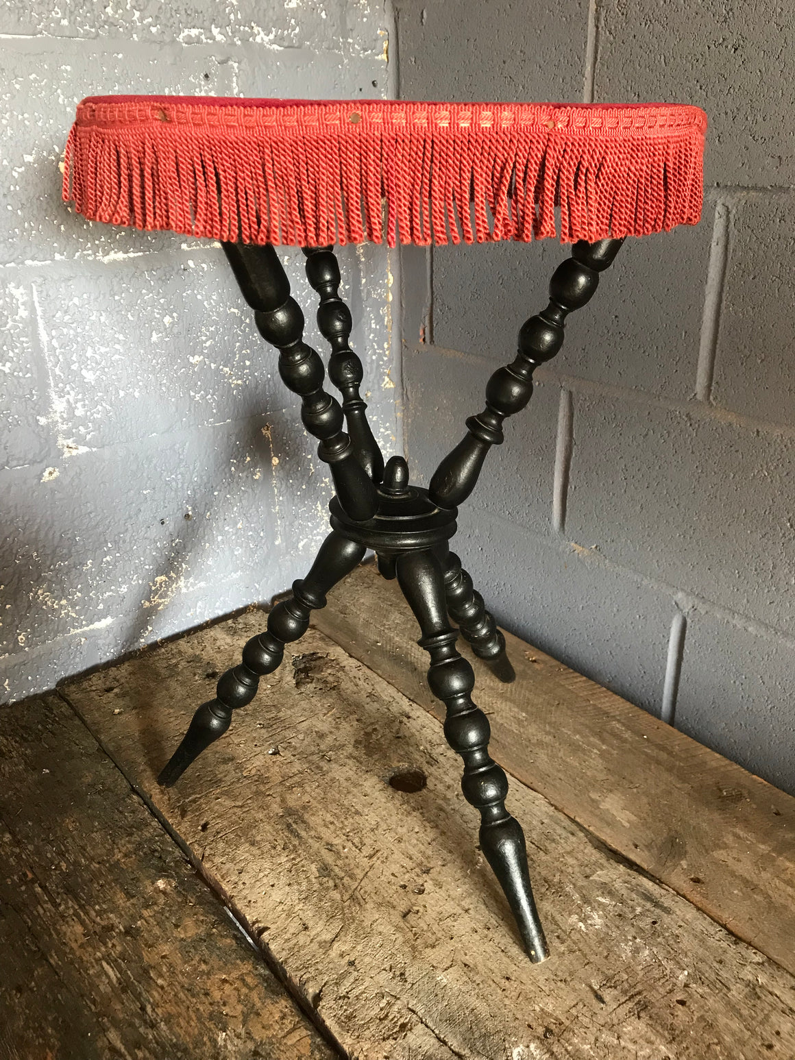 An early ebonised bobbin gypsy table with red velvet top