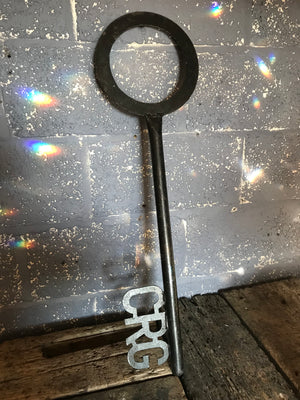 A large black metal key trade sign from a locksmiths