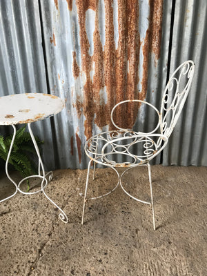 An elegant French white metal chair and table