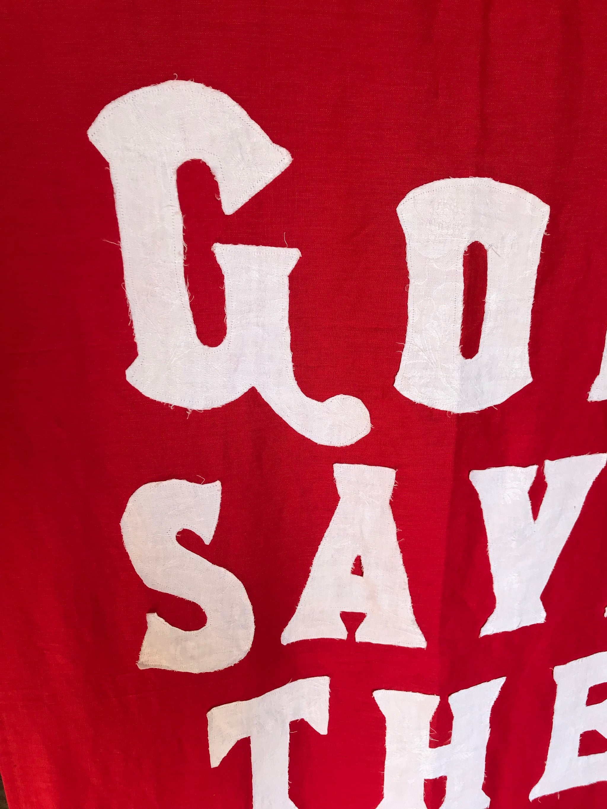 A red WWI centenary coronation banner: "God Save The King"