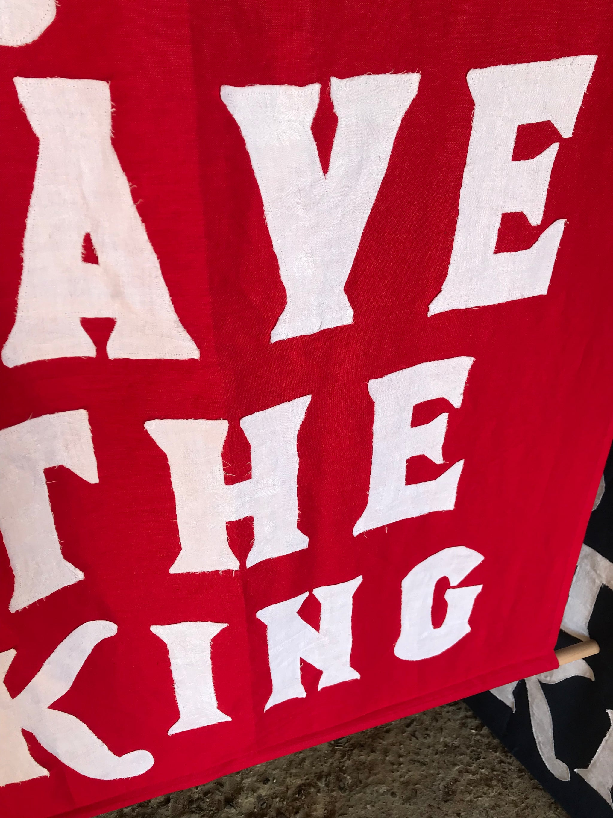 A red WWI centenary coronation banner: "God Save The King"