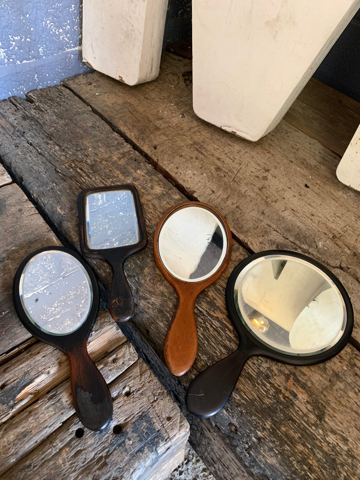 A set of four hand held dressing table vanity mirrors