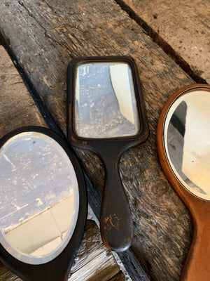 A set of four hand held dressing table vanity mirrors