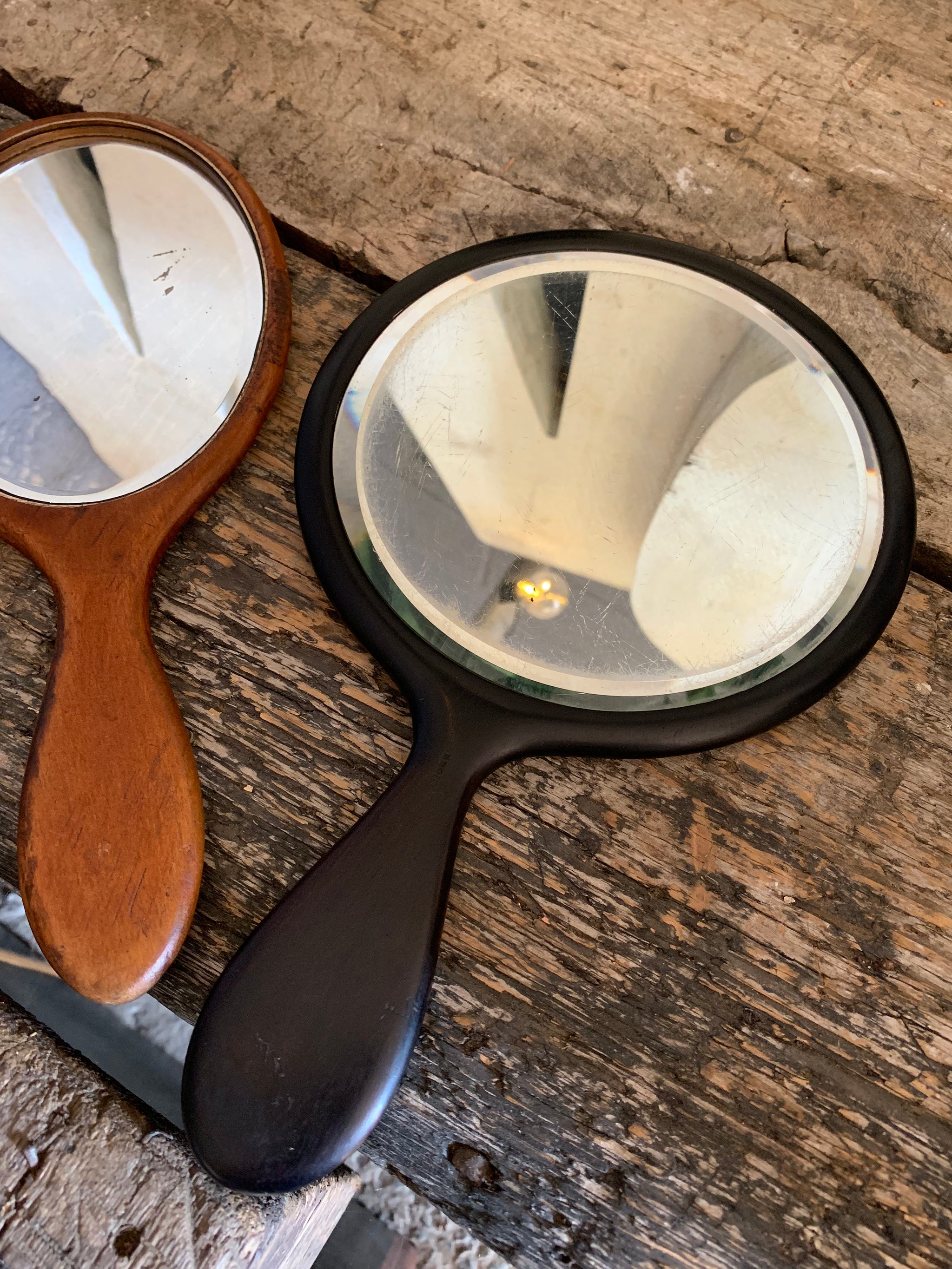 A set of four hand held dressing table vanity mirrors