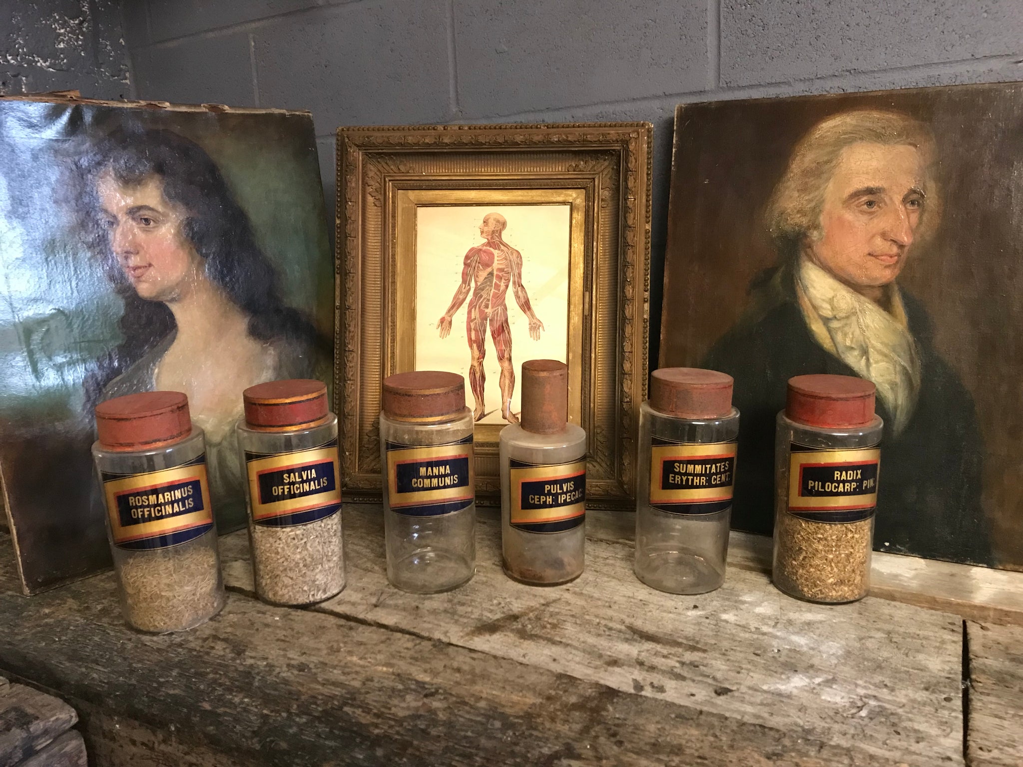 A collection of six gilt label large glass apothecary jars