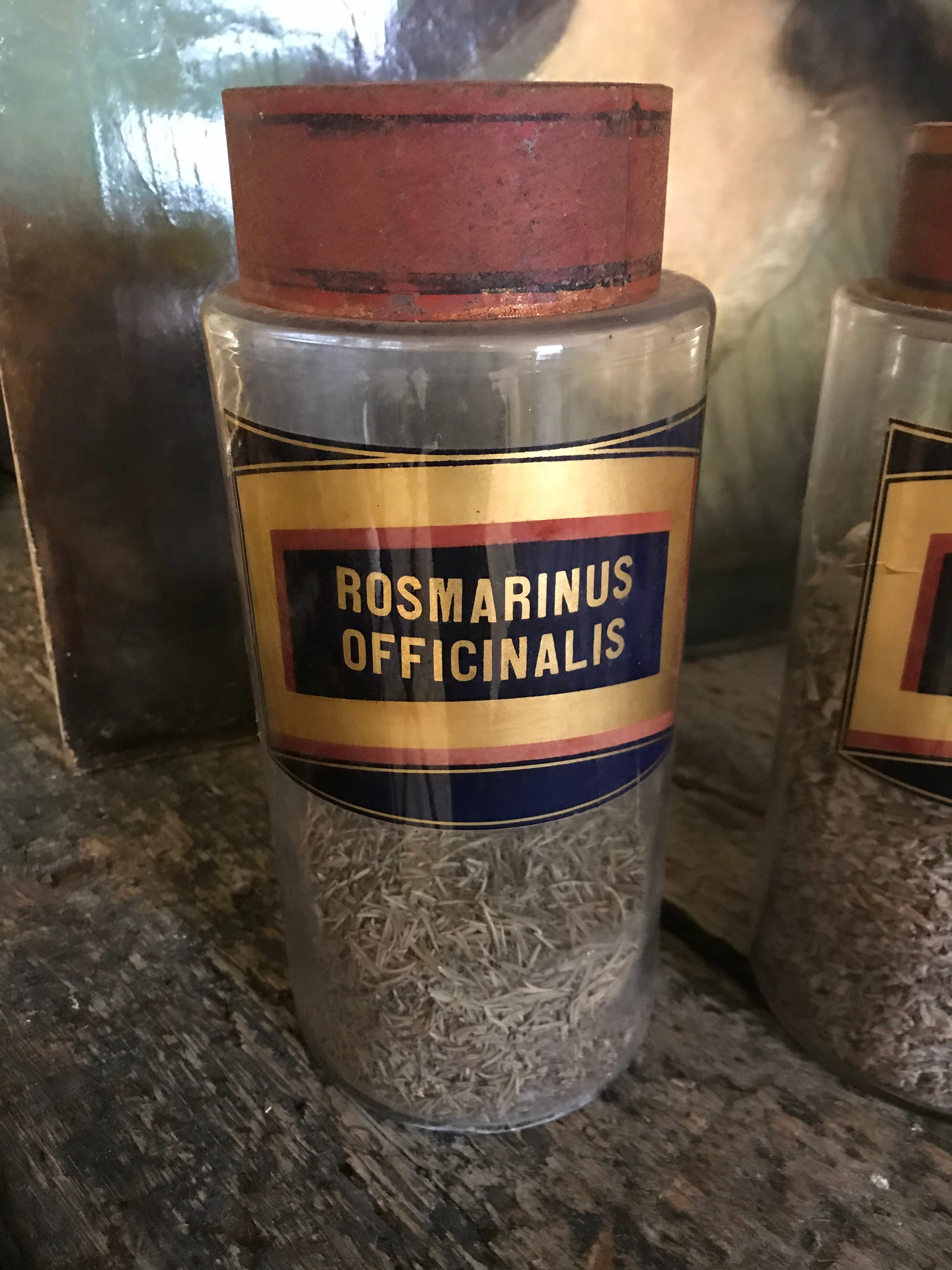 A collection of six gilt label large glass apothecary jars