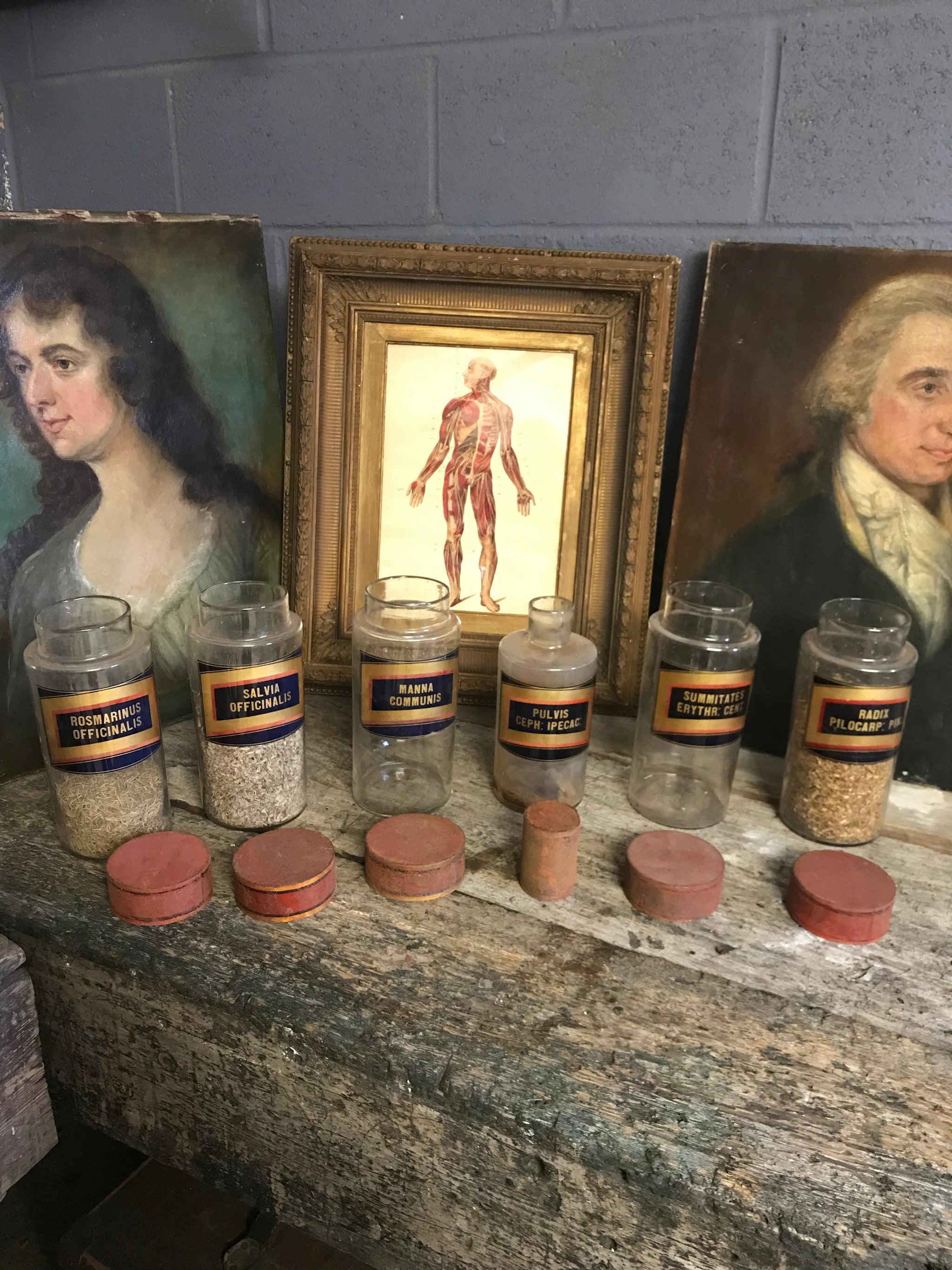A collection of six gilt label large glass apothecary jars