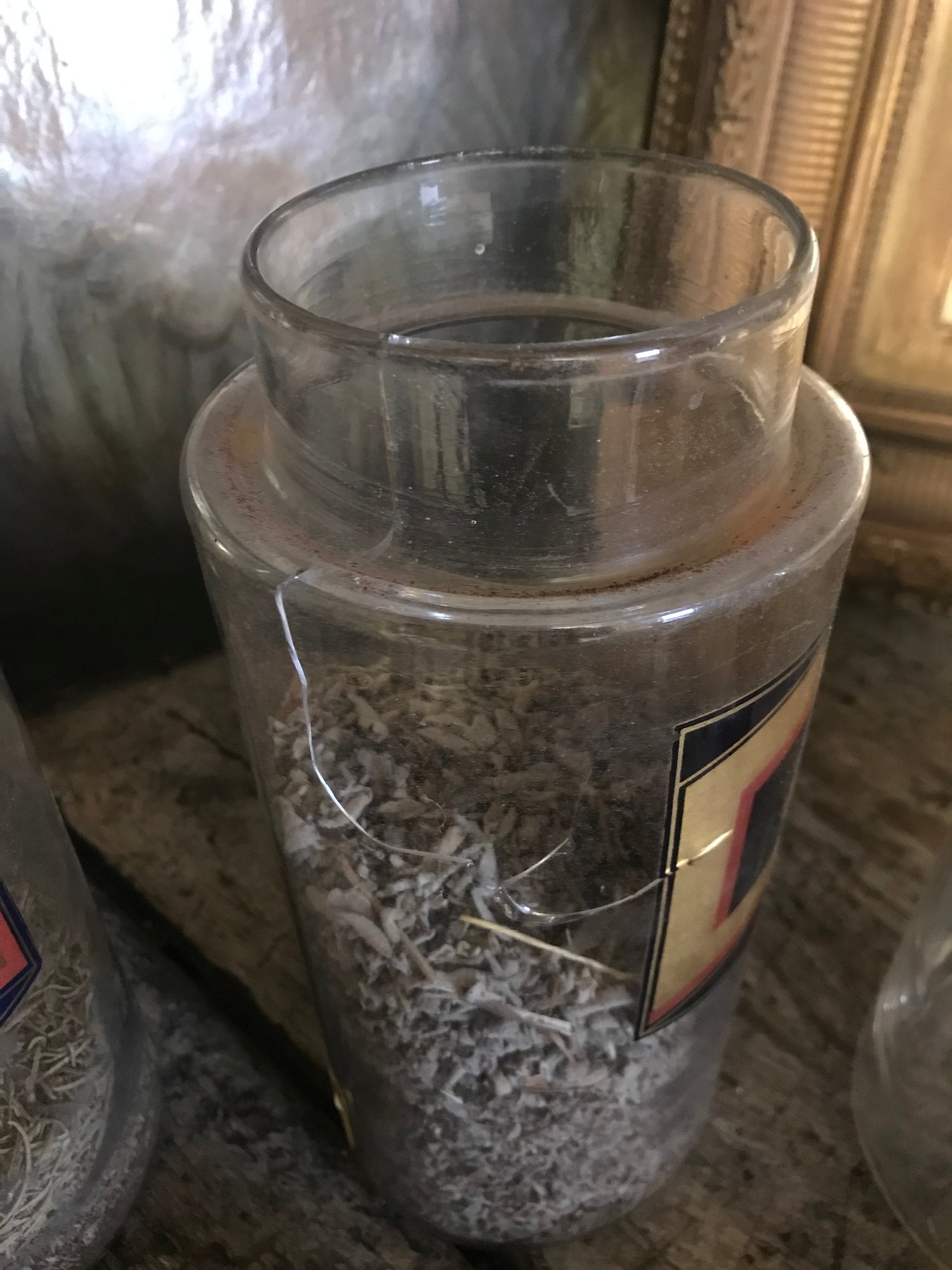 A collection of six gilt label large glass apothecary jars