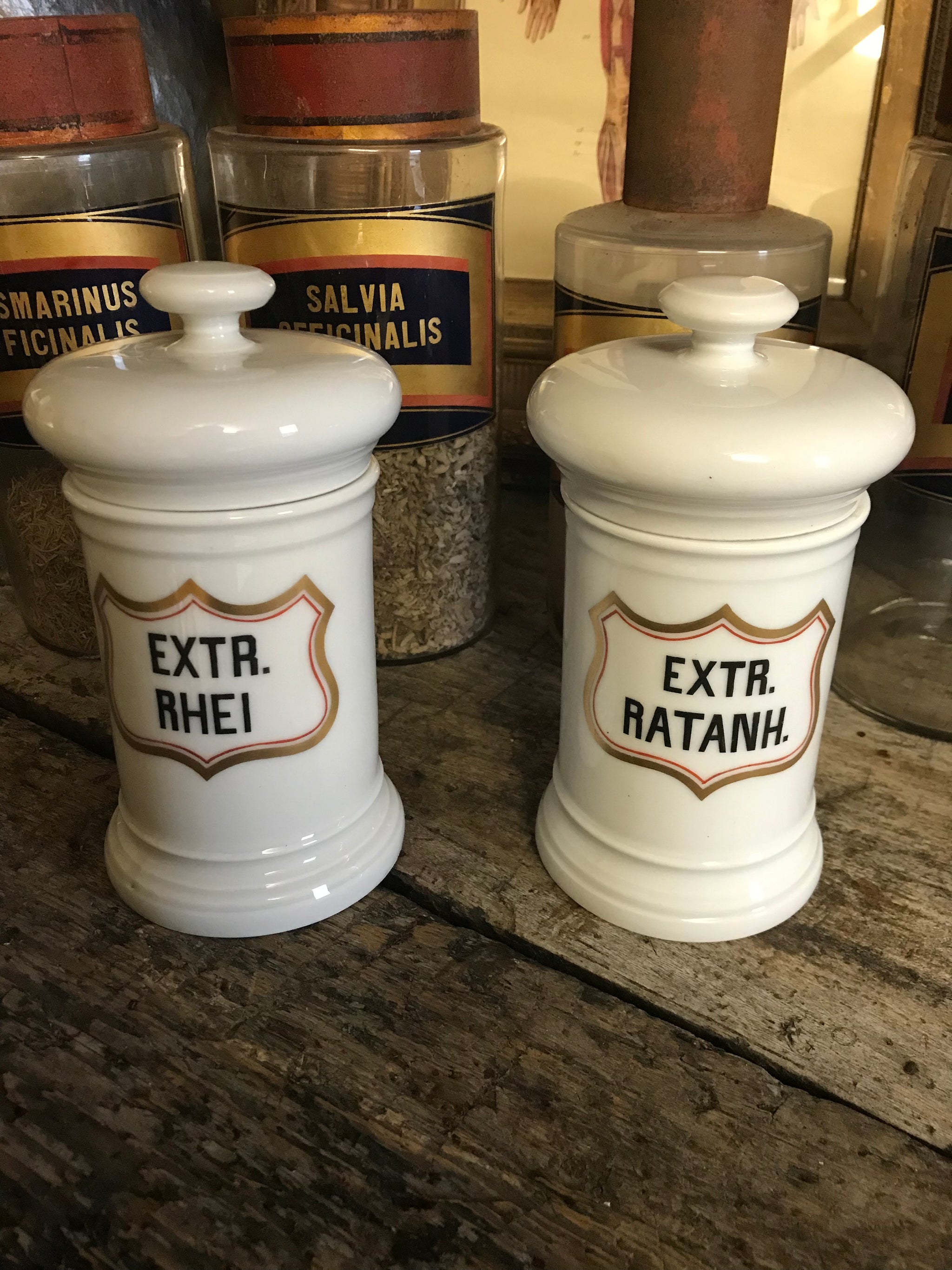 A pair of large white porcelain apothecary jars with lids