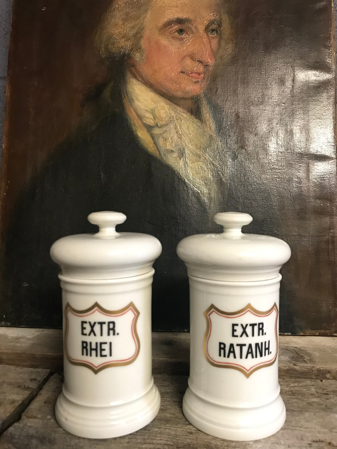 A pair of large white porcelain apothecary jars with lids