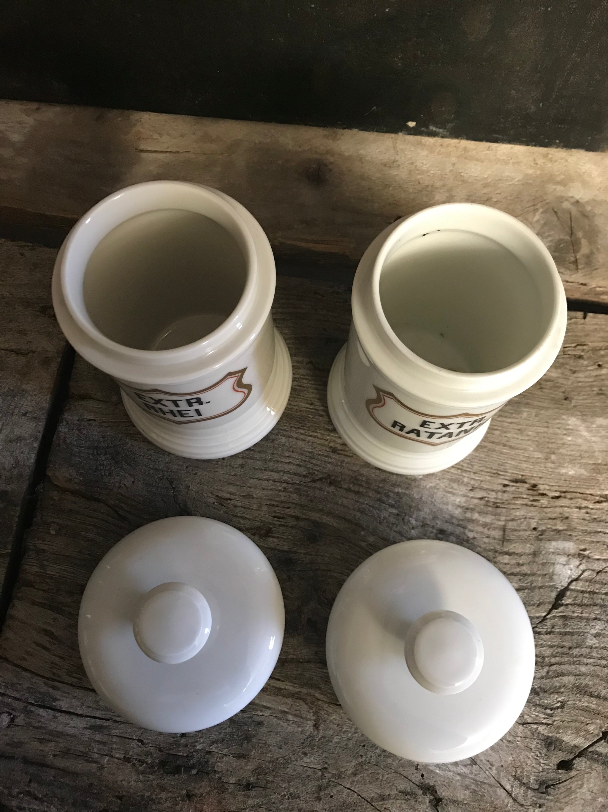 A pair of large white porcelain apothecary jars with lids