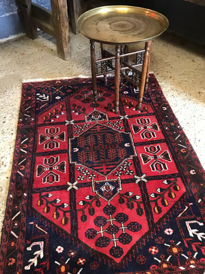 A Persian red and blue ground lozenge rectangular rug