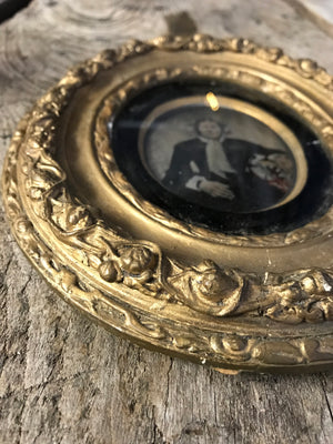 A hand tinted portrait Daguerreotype photograph in an oval gilt frame- large