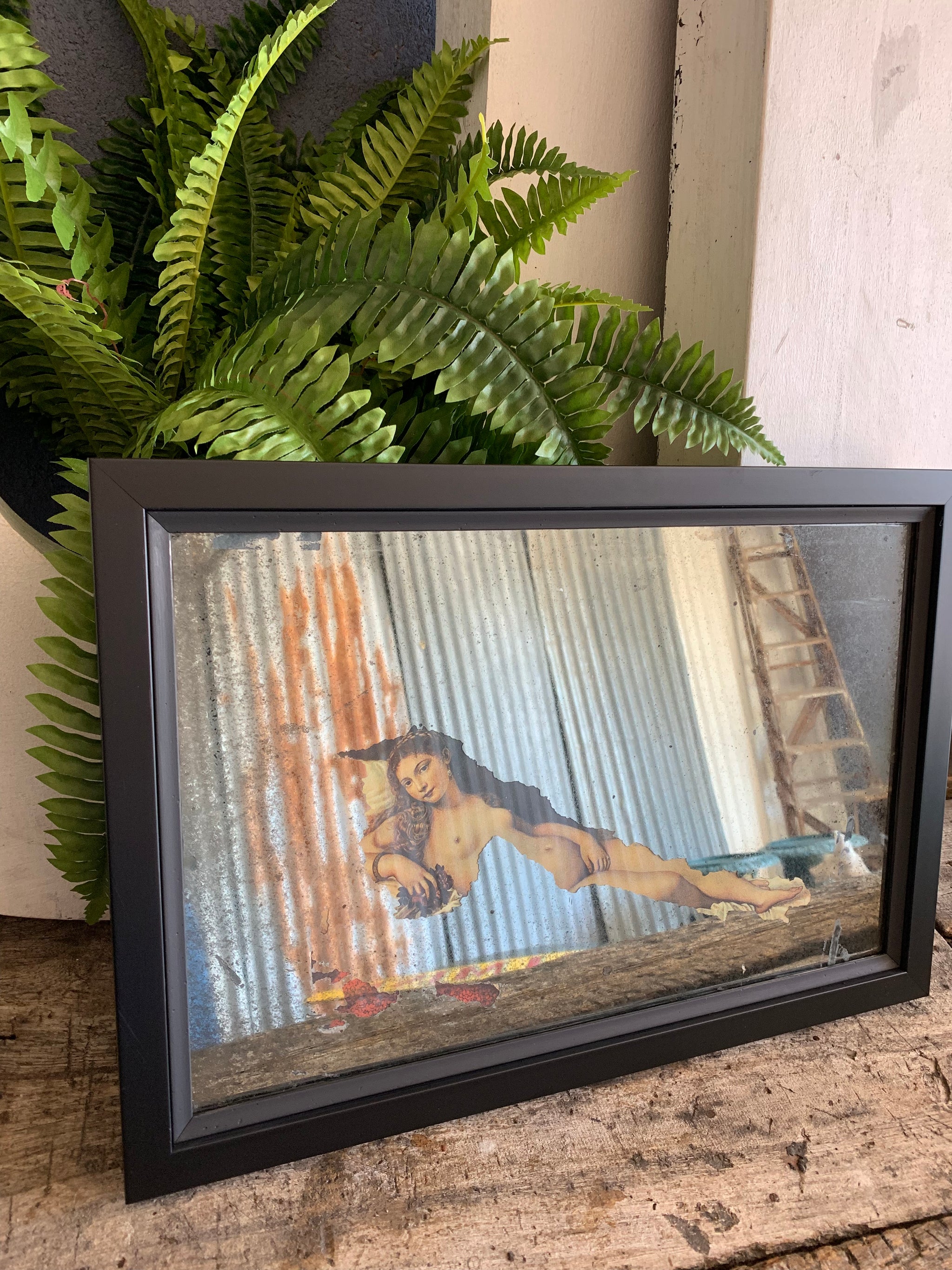 A foxed mercury glass mirror revealing the Venus of Urbino by Titian