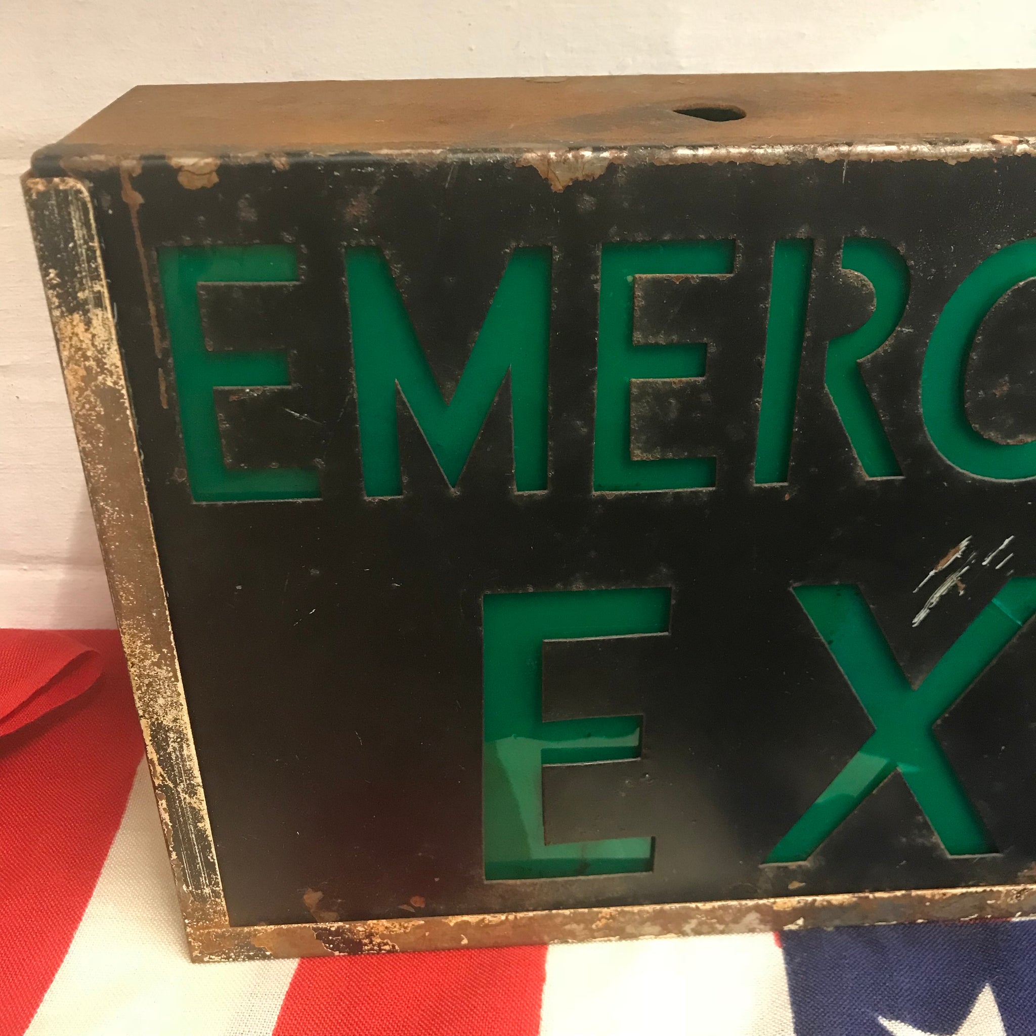 A metal emergency exit light box sign