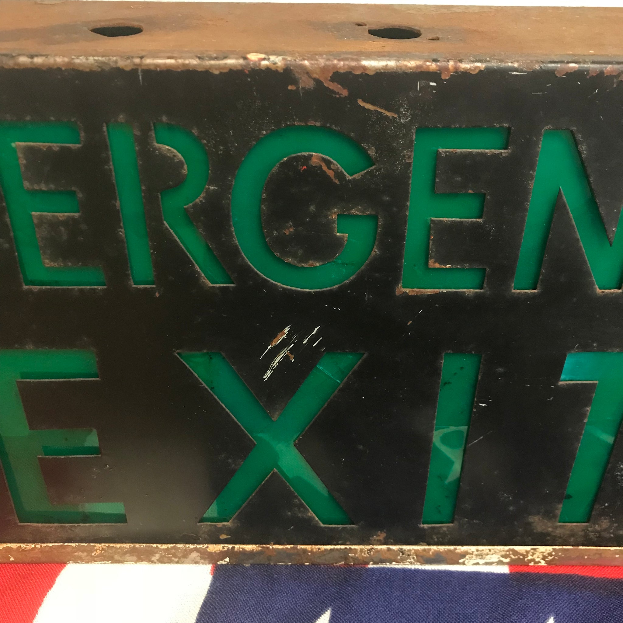 A metal emergency exit light box sign