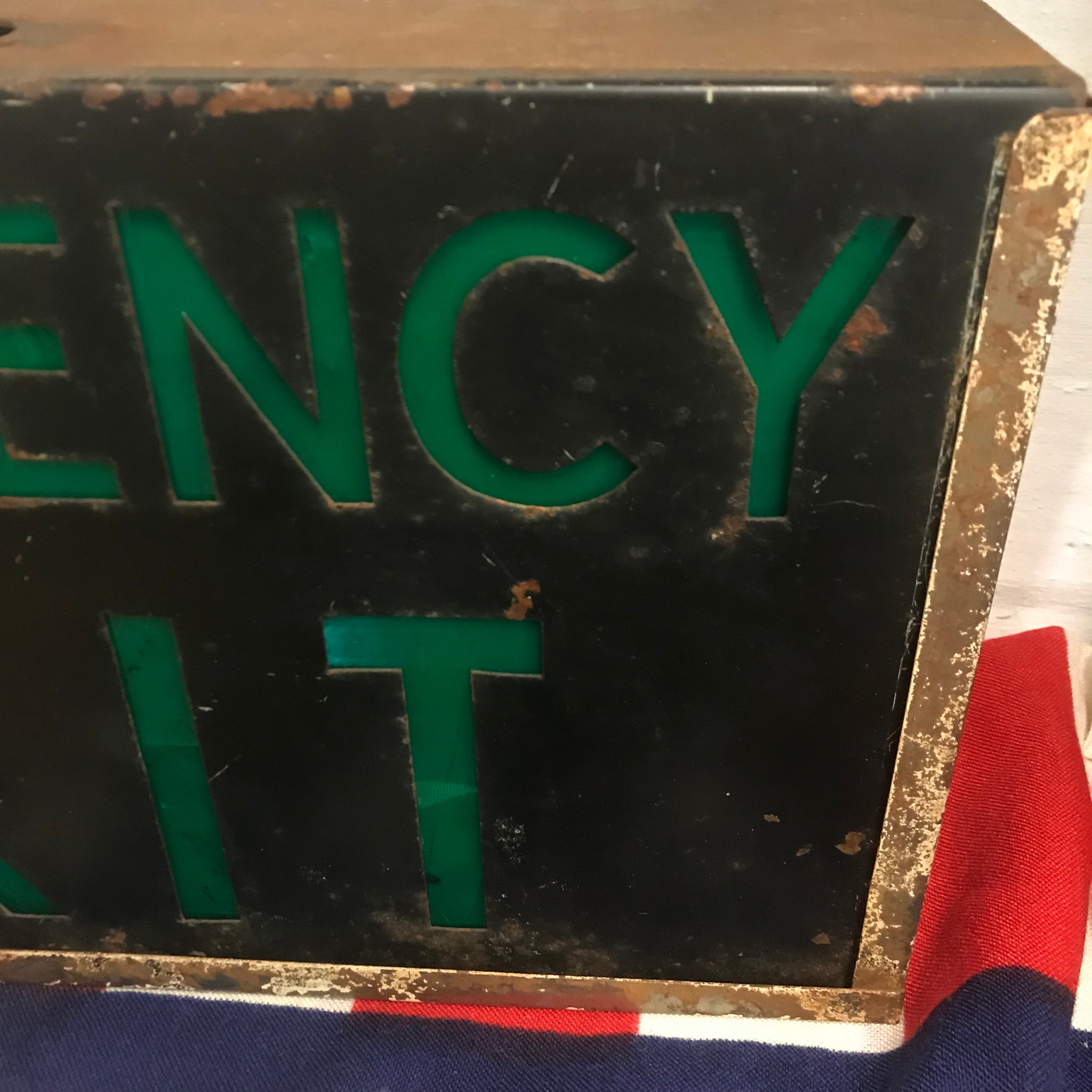 A metal emergency exit light box sign