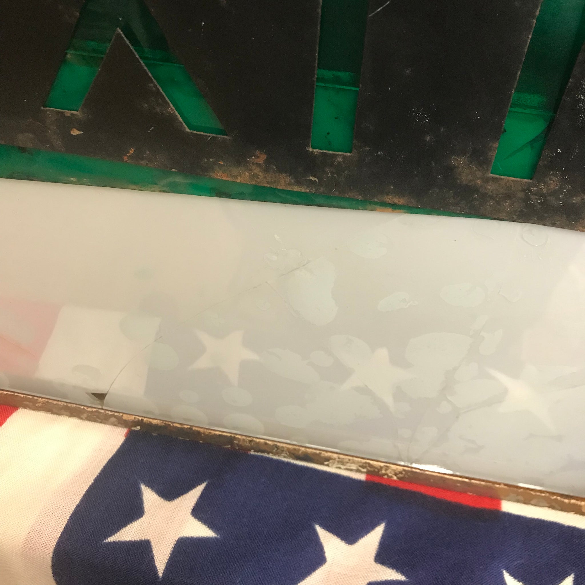 A metal emergency exit light box sign