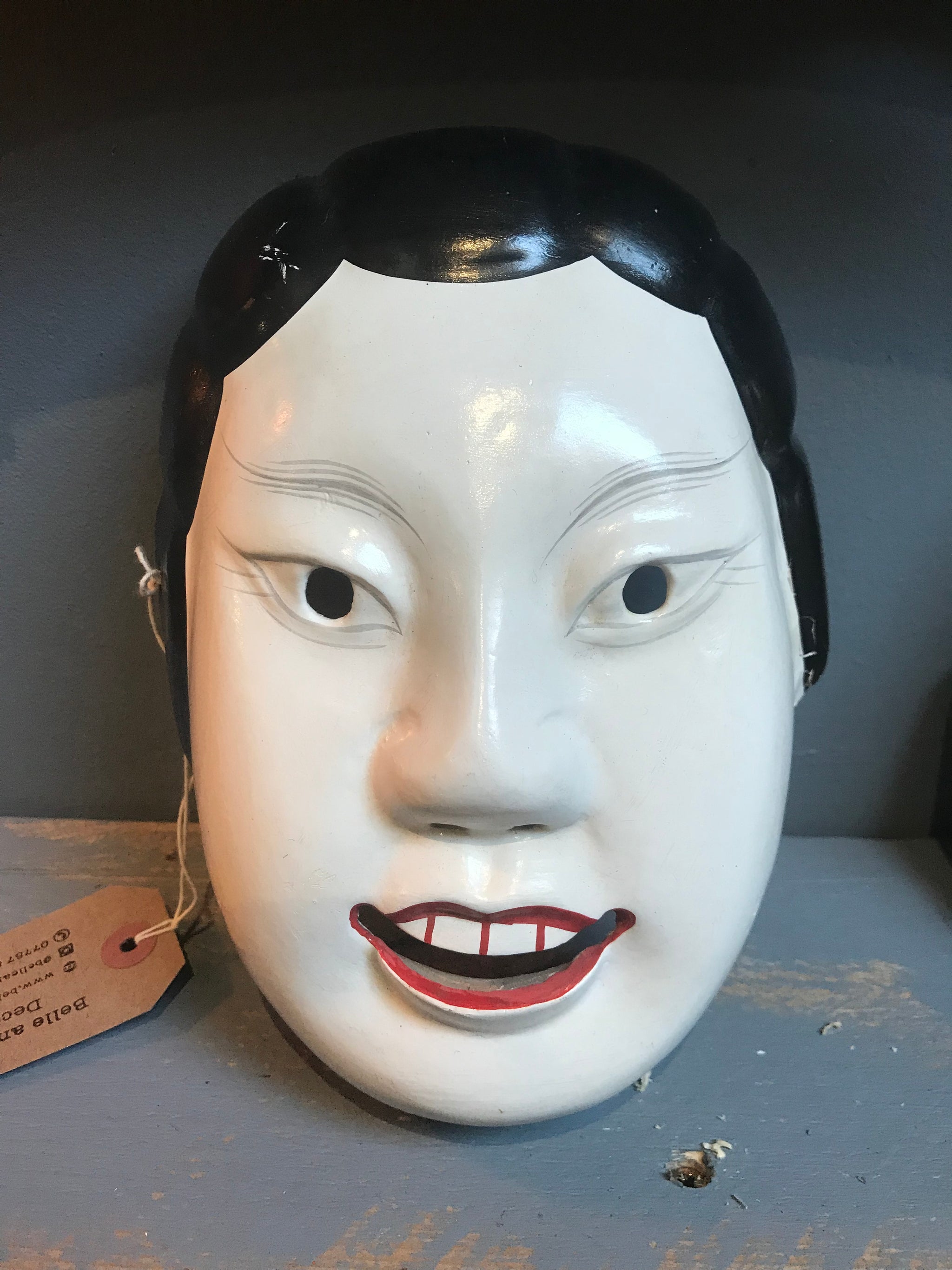 A carved wooden hand-painted Japanese noh mask