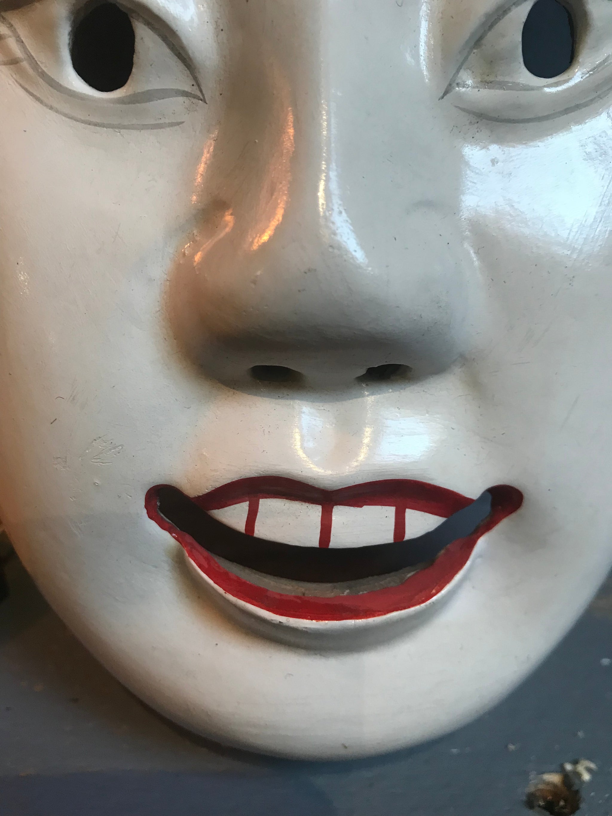 A carved wooden hand-painted Japanese noh mask