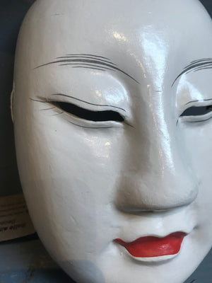 A carved wooden hand-painted Japanese noh mask