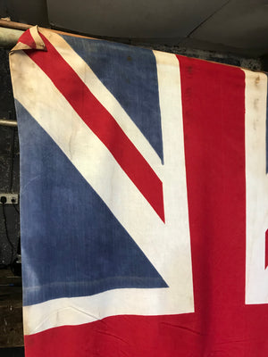 A very large Union Jack flag on a wooden pole