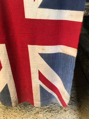 A very large Union Jack flag on a wooden pole
