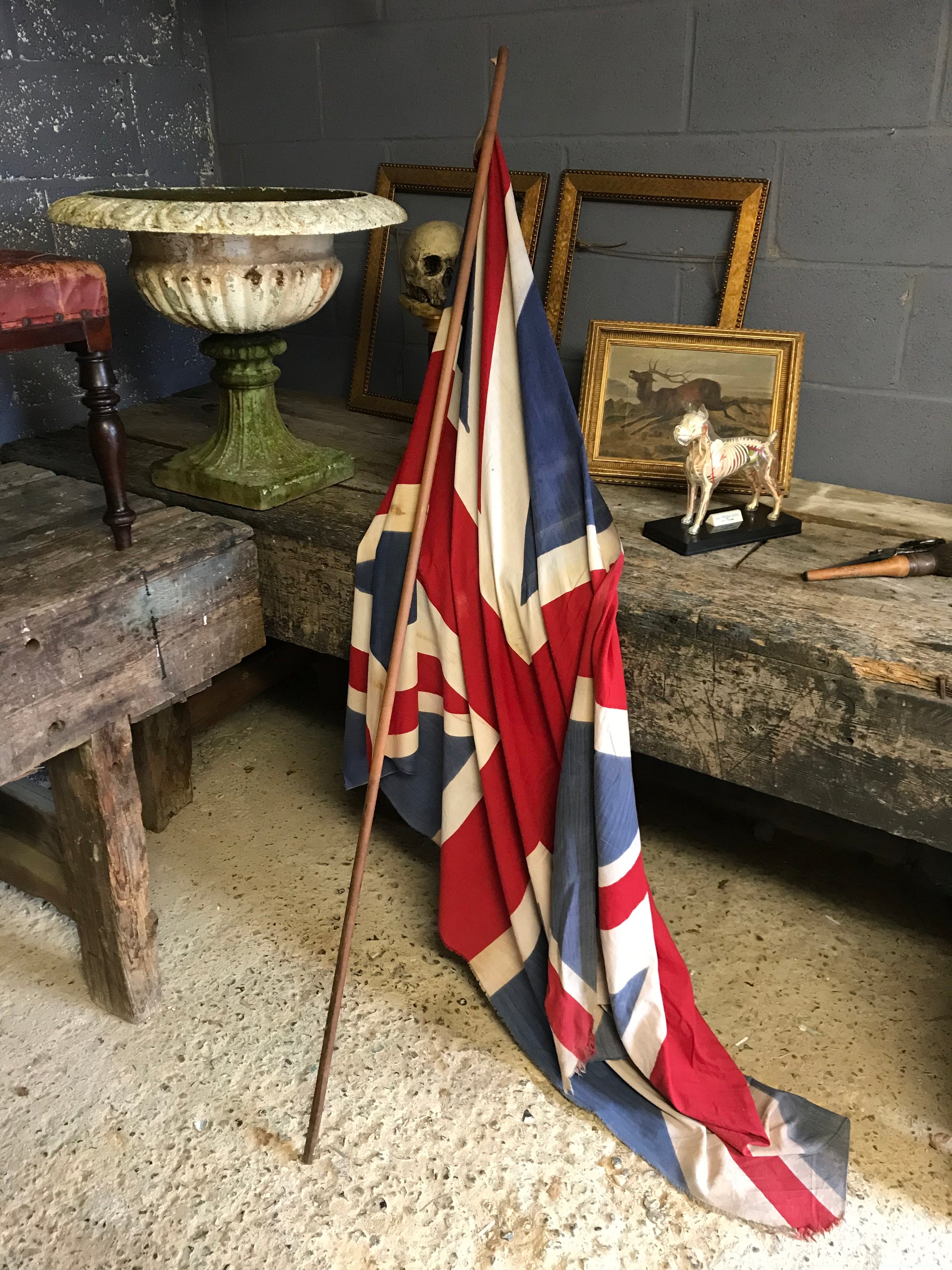 A very large Union Jack flag on a wooden pole