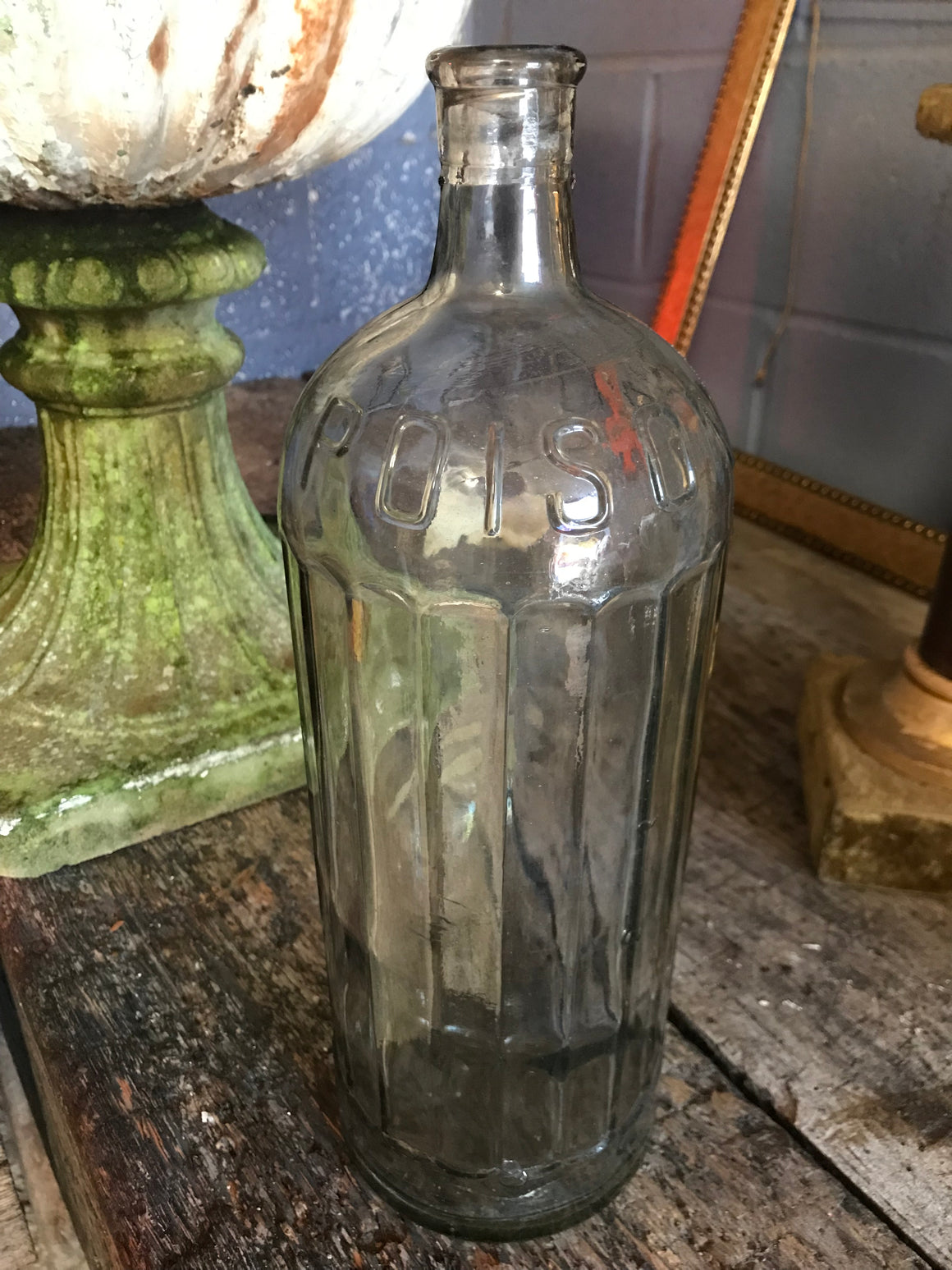 A large iridescent apothecary poison bottle