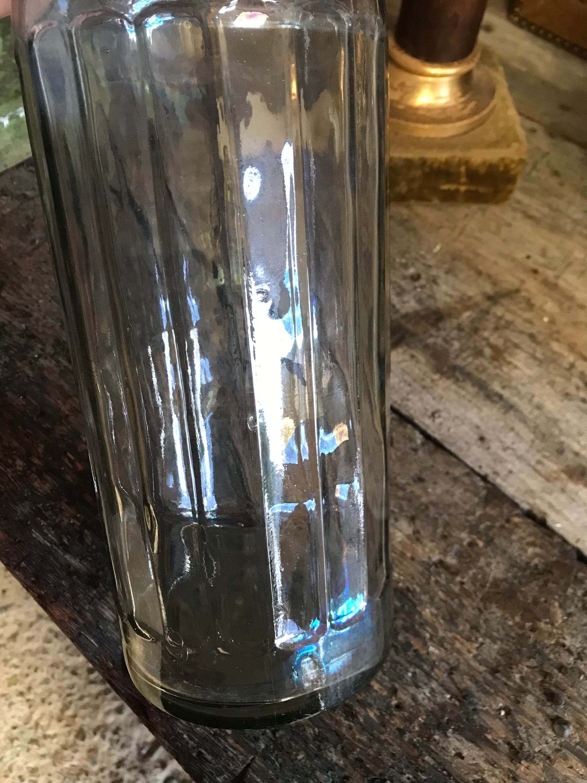 A large iridescent apothecary poison bottle