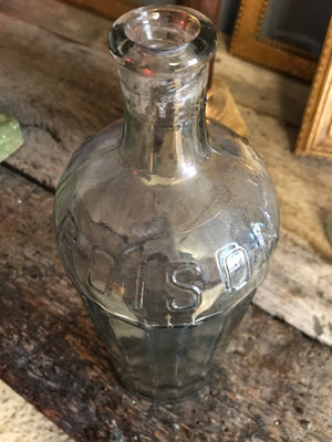 A large iridescent apothecary poison bottle
