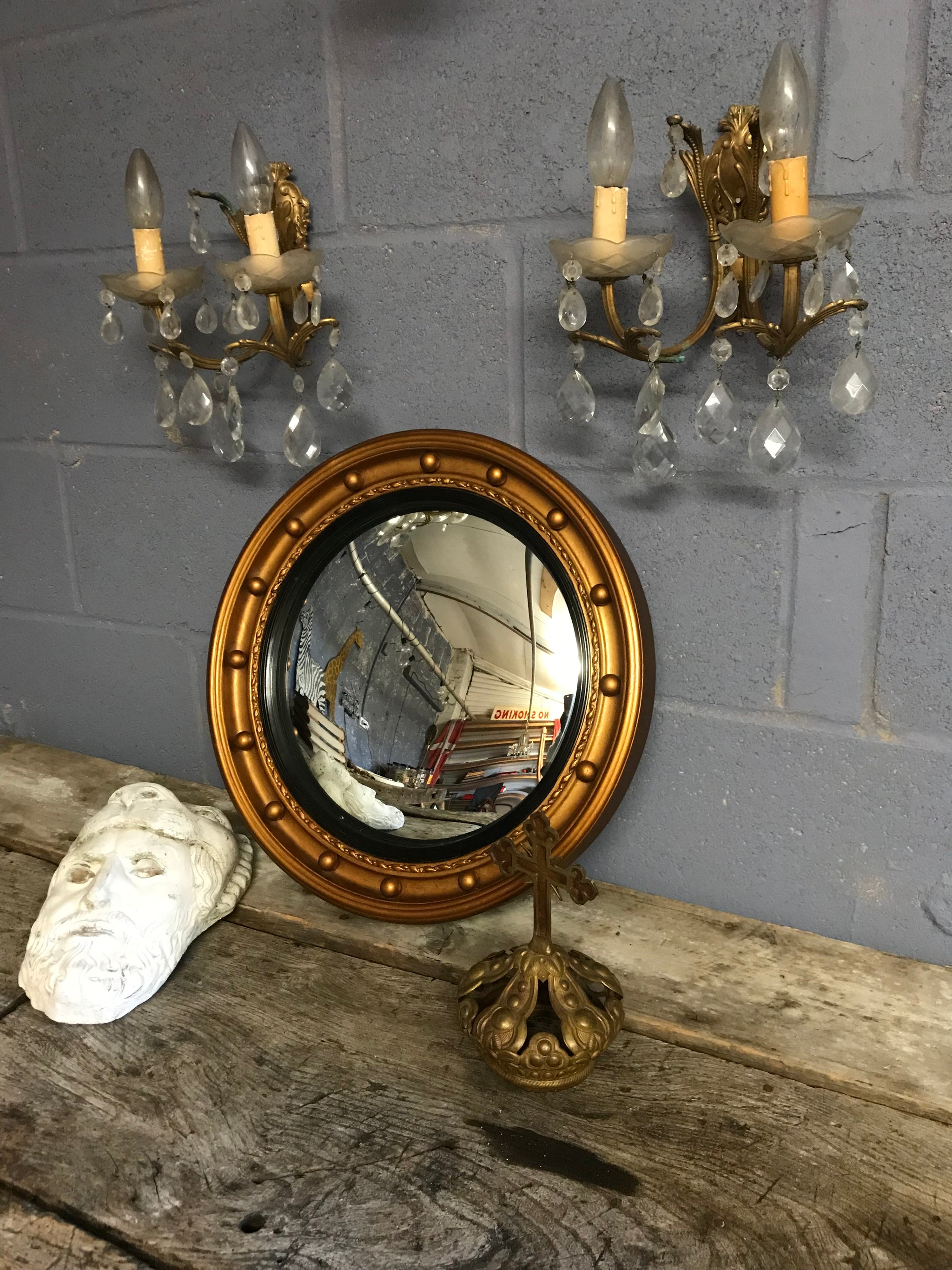A large gilt convex ball mirror