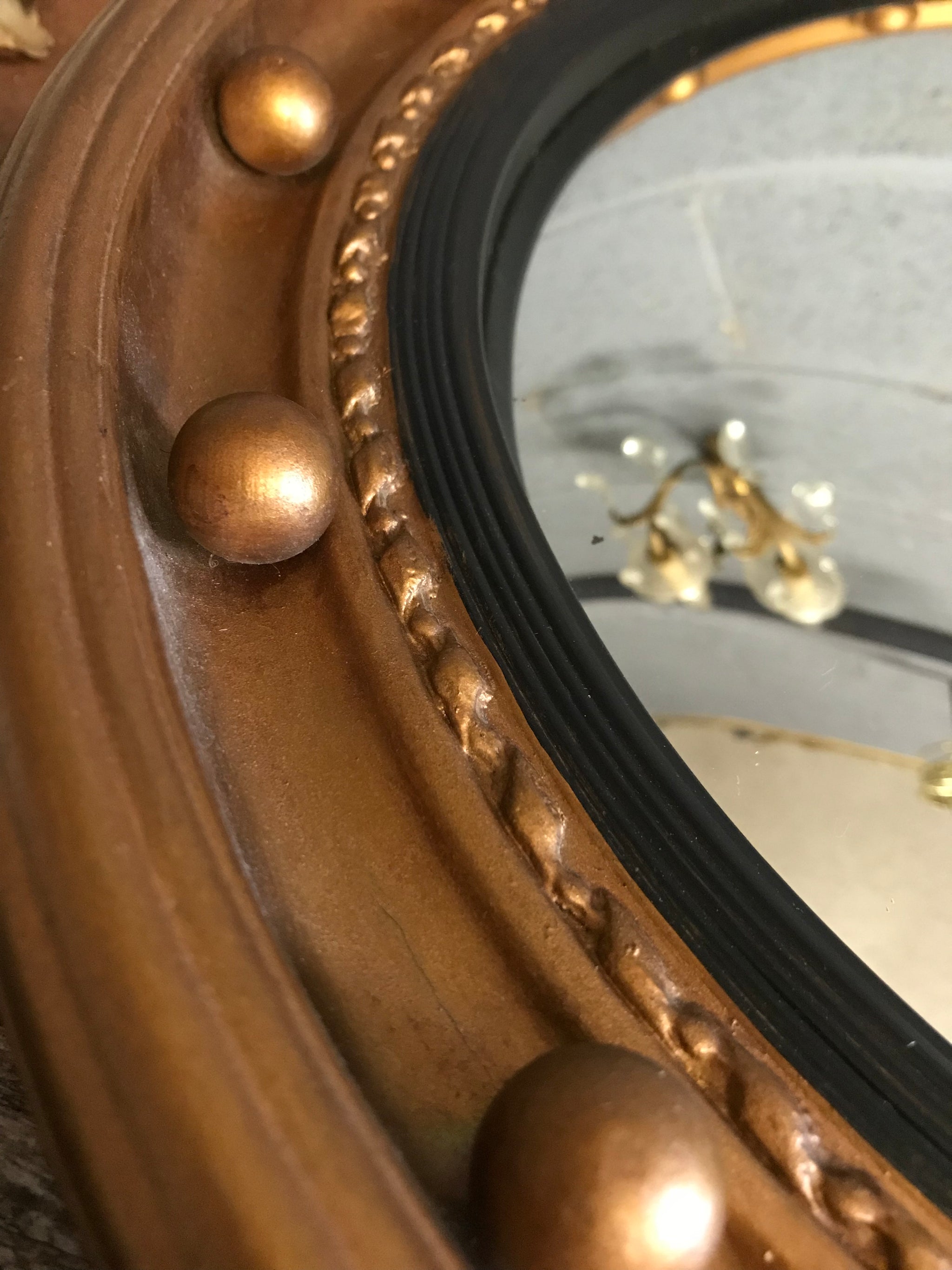 A large gilt convex ball mirror