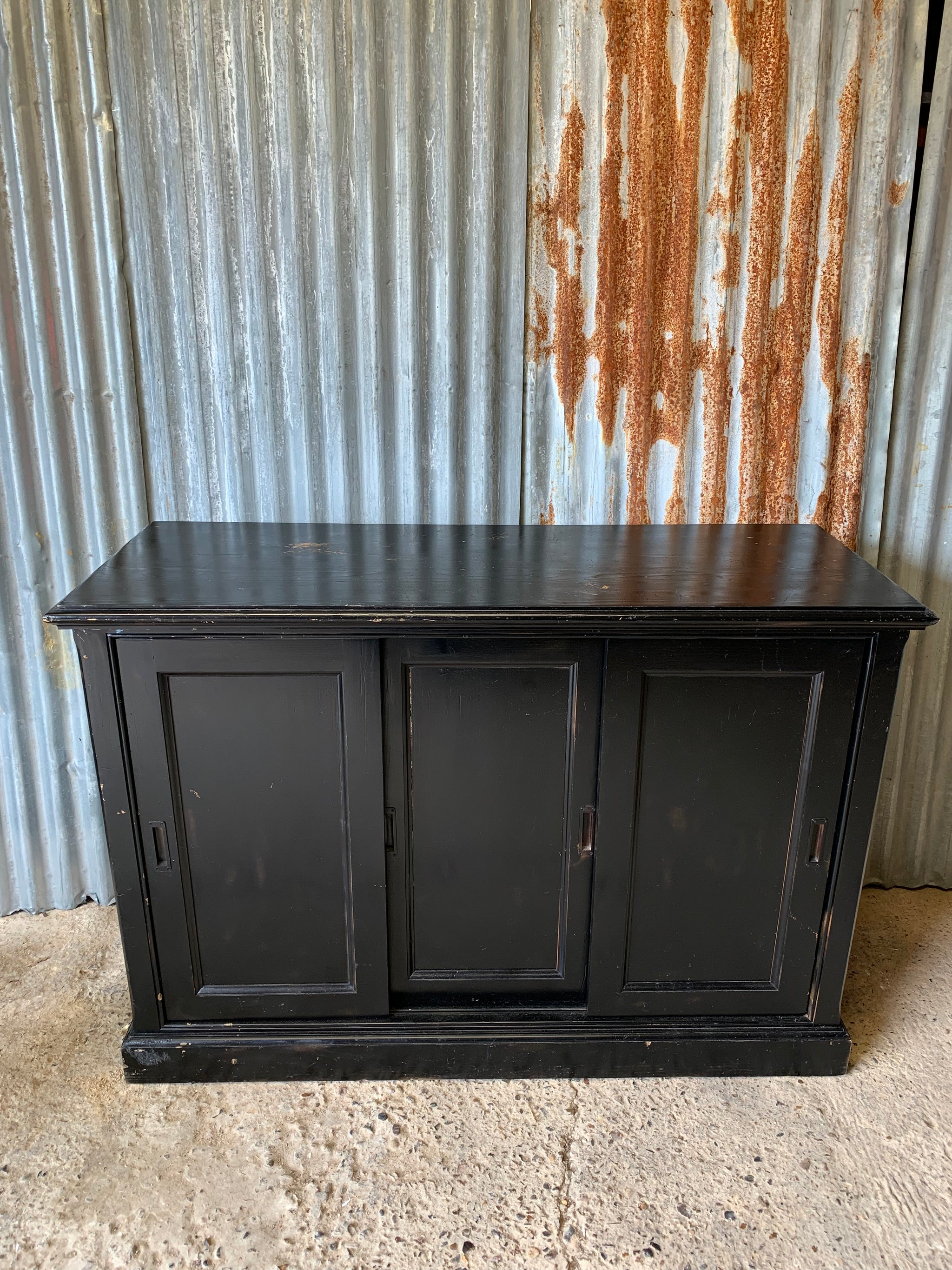 A black ebonised shop counter display cabinet