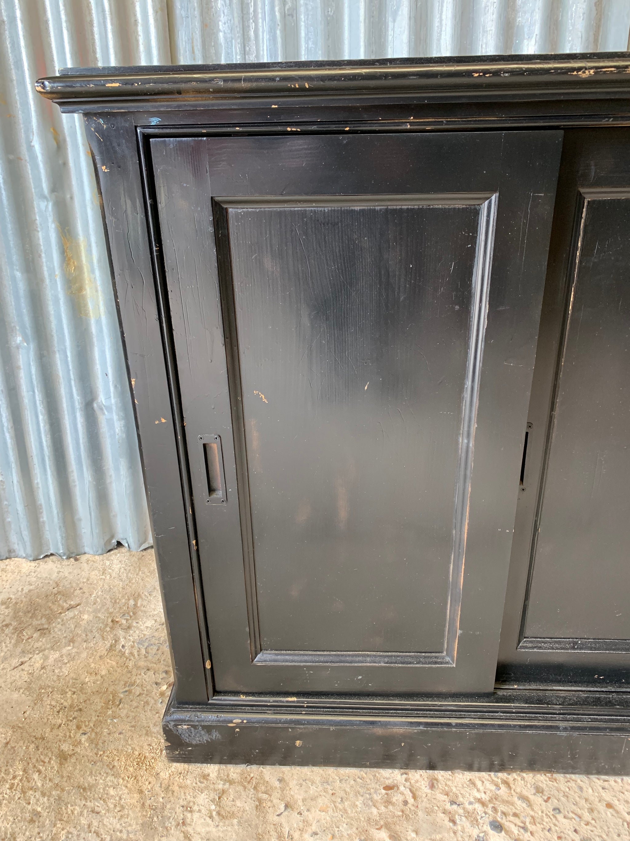A black ebonised shop counter display cabinet