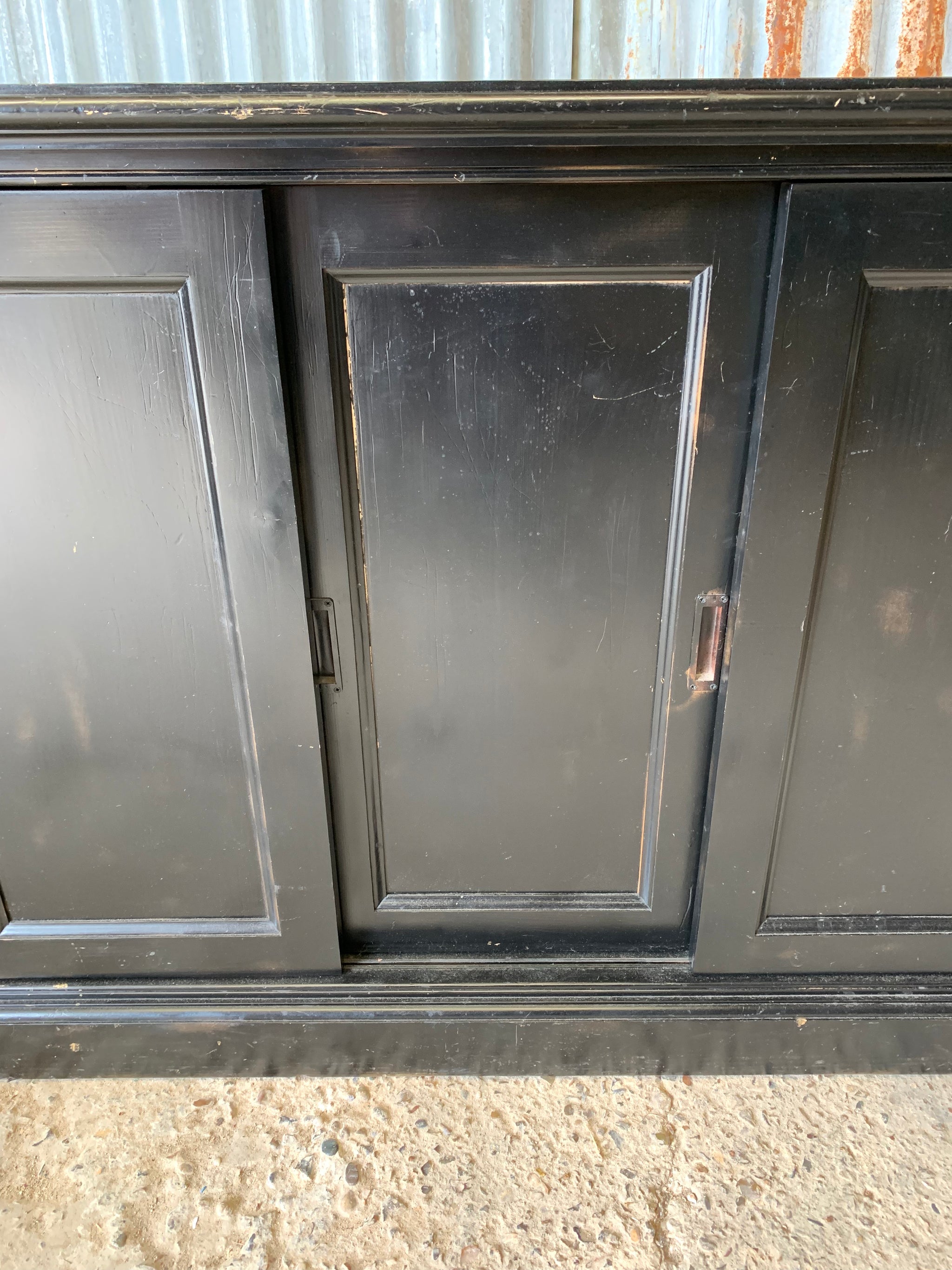 A black ebonised shop counter display cabinet