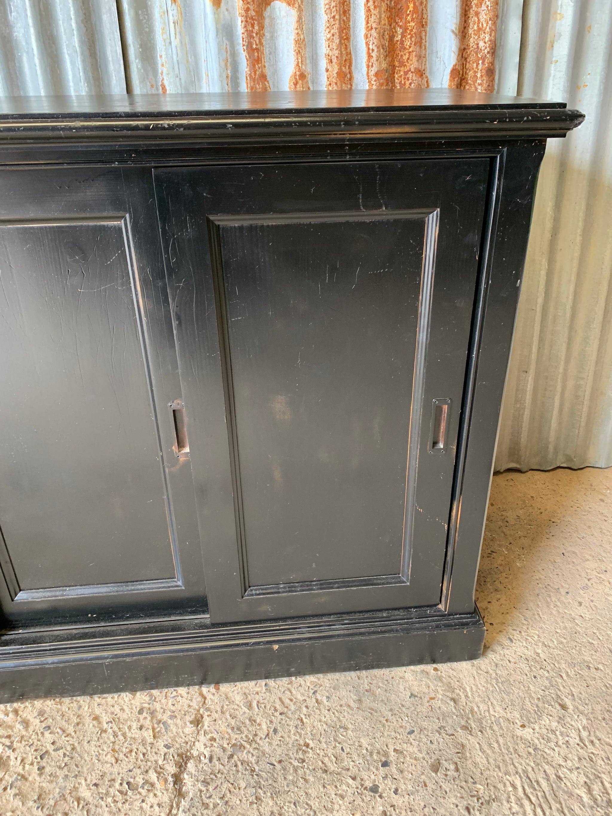 A black ebonised shop counter display cabinet